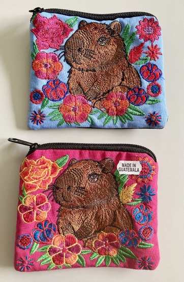 Handcrafted suede zipper coin purse featuring an adorable artisan embroidered capybara motif.