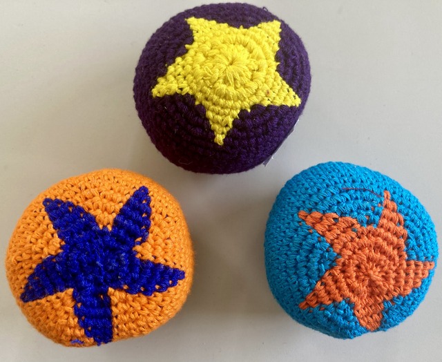 Handmade cotton footbag intricately crocheted with custom colorful star motifs by Mayan craftspeople.