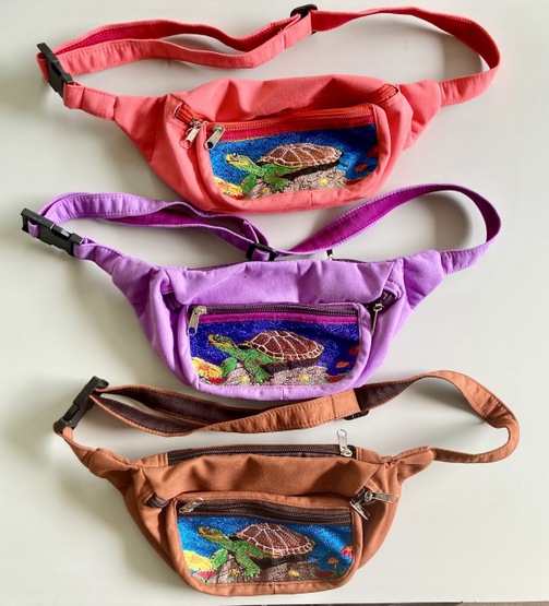 Artisan waist bag featuring hand-woven turtle pattern textiles accented with high quality leather straps and zip pullers.