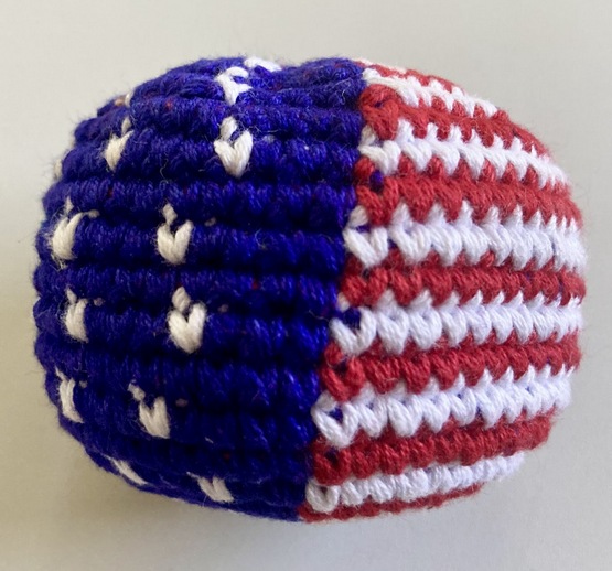 Hand-crocheted cotton footbag featuring a red white and blue US Flag design handmade by Guatemalan artisans.