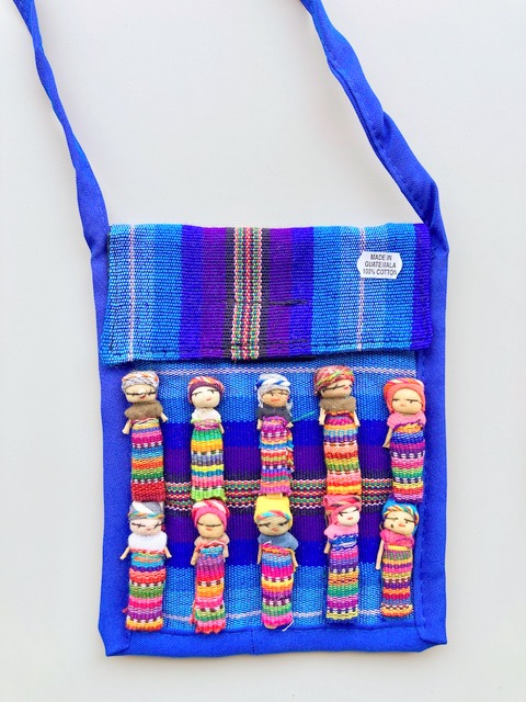 Colorful hand-woven worry doll passport purse with artisan fabric